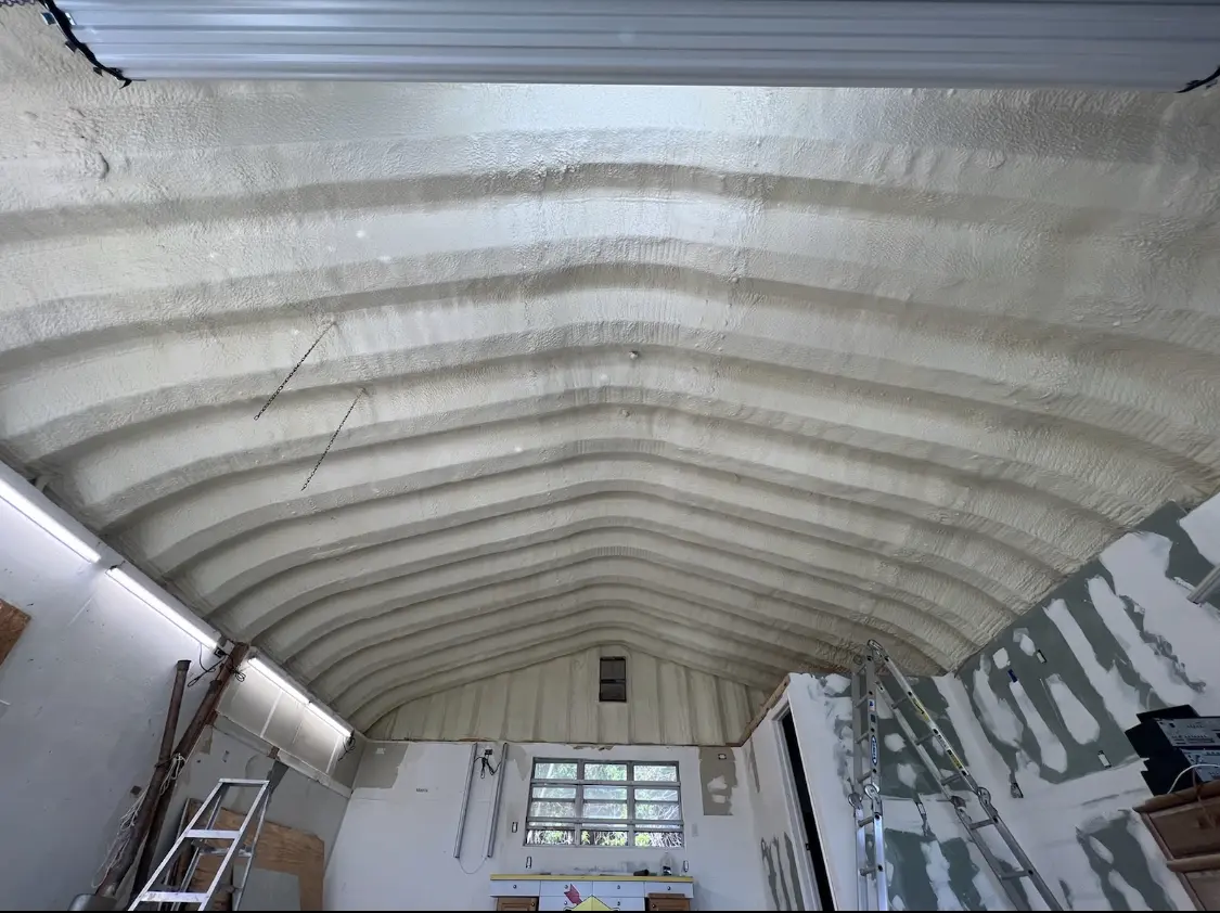 Spray polyurethane foam applied to the underside of a metal roof deck in Front Royal